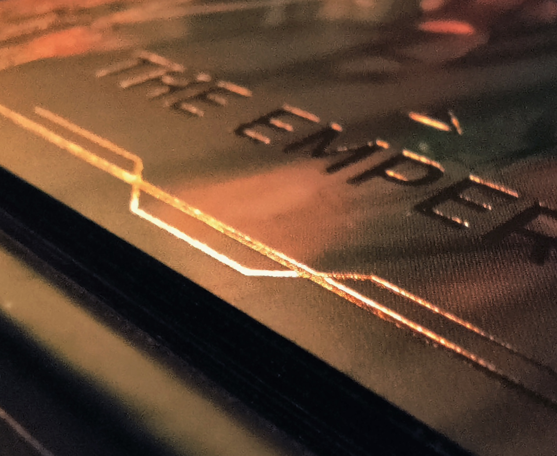 A close up of the card graphic, set in gold foil.